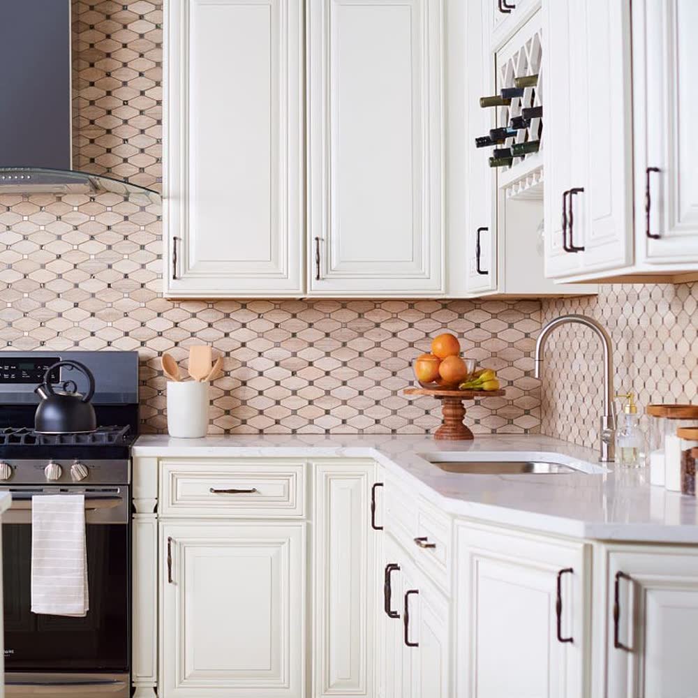 Charleston White kitchen cabinets shown in a finished kitchen — antique cream raised-panel doors