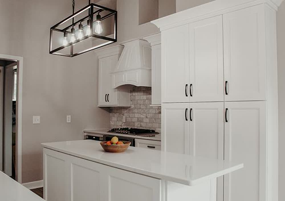 Double Dove White kitchen cabinets shown in a finished kitchen — white shaker doors