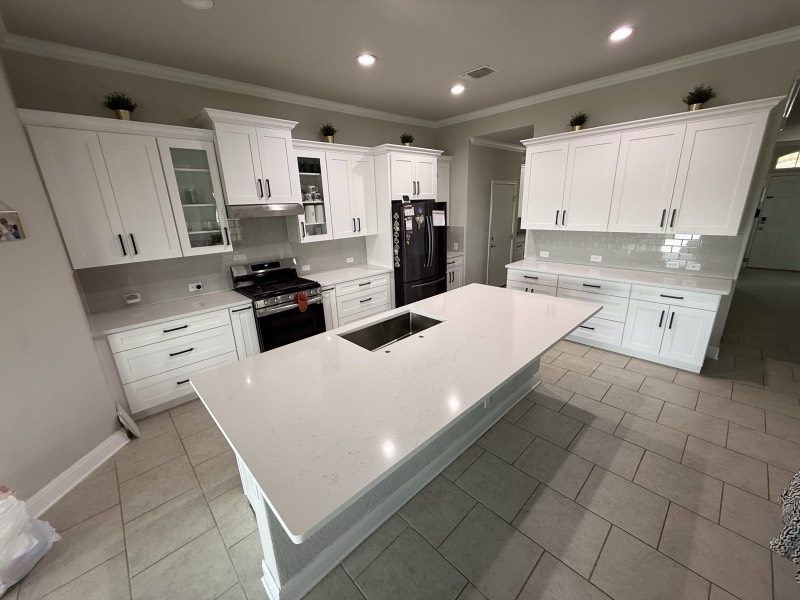 Large white quartz island in a bright San Antonio kitchen