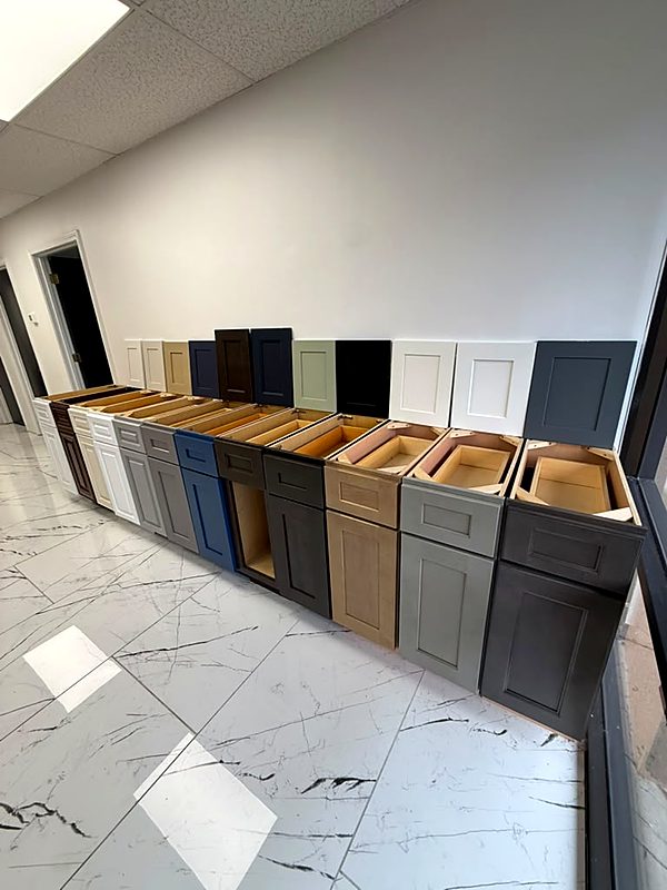 A row of sample base cabinets in different finishes at the Cabinet Bazaar showroom
