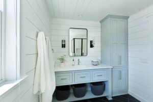 bathroom cabinets in San Antonio for all bathroom sizes- A contemporary modern bathroom design for a country home cabin. featuring a classic freestanding vanity and linen storage cabinet.
